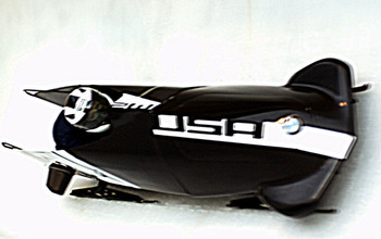 Driver in bobsled with USA on front